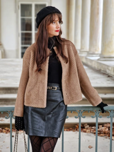 a lady wears a brown eco-friendly fur coat with a black leather skirt